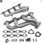 Metal exhaust manifold set with gaskets and bolts on a white background