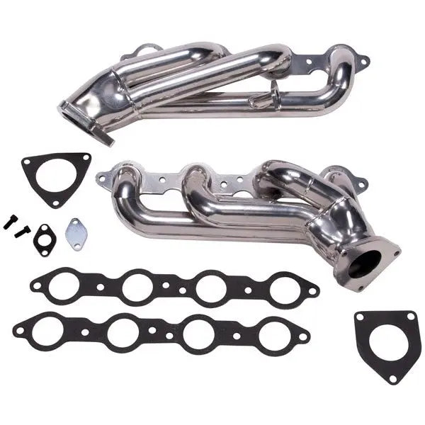 Metal exhaust manifold set with gaskets on a white background
