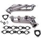 Metal exhaust manifold set with gaskets on a white background