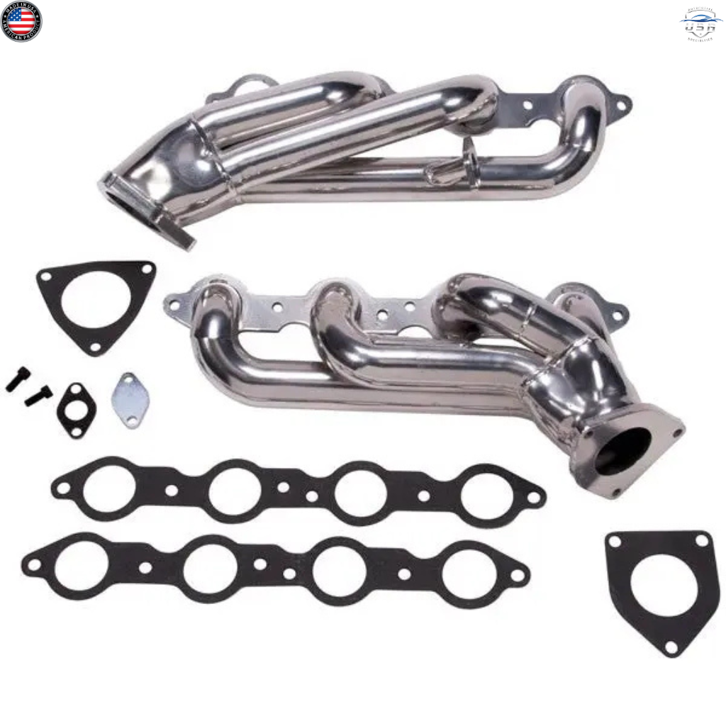 Metal exhaust manifold set with gaskets on a white background