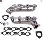 Metal exhaust manifold set with gaskets on a white background