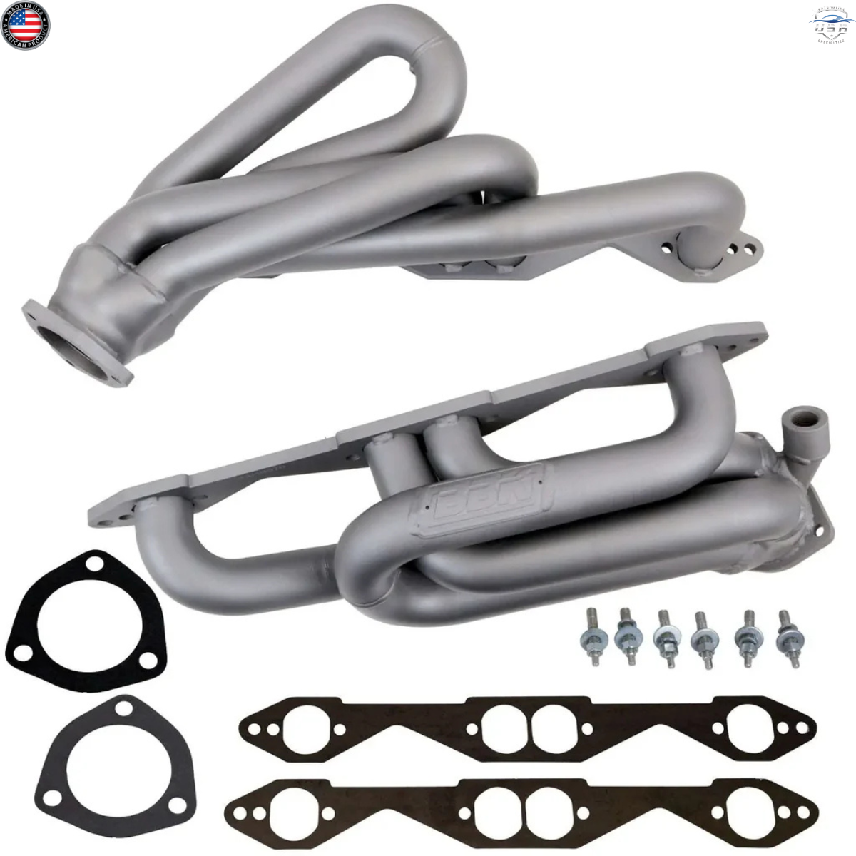 Set of gray exhaust manifolds with gaskets and bolts on a white background