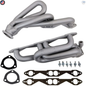 Set of gray exhaust manifolds with gaskets and bolts on a white background