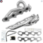 Car exhaust manifold kit with gaskets and hardware on a white background