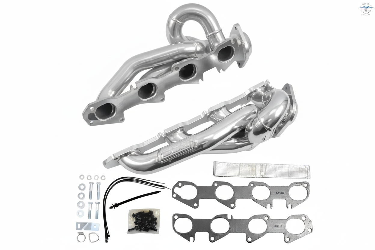 Metallic exhaust manifold set with gaskets and bolts on a white background