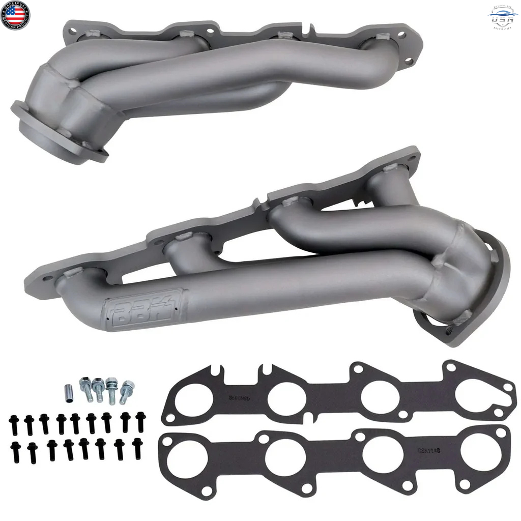 Set of gray exhaust manifolds with gaskets and bolts on a white background