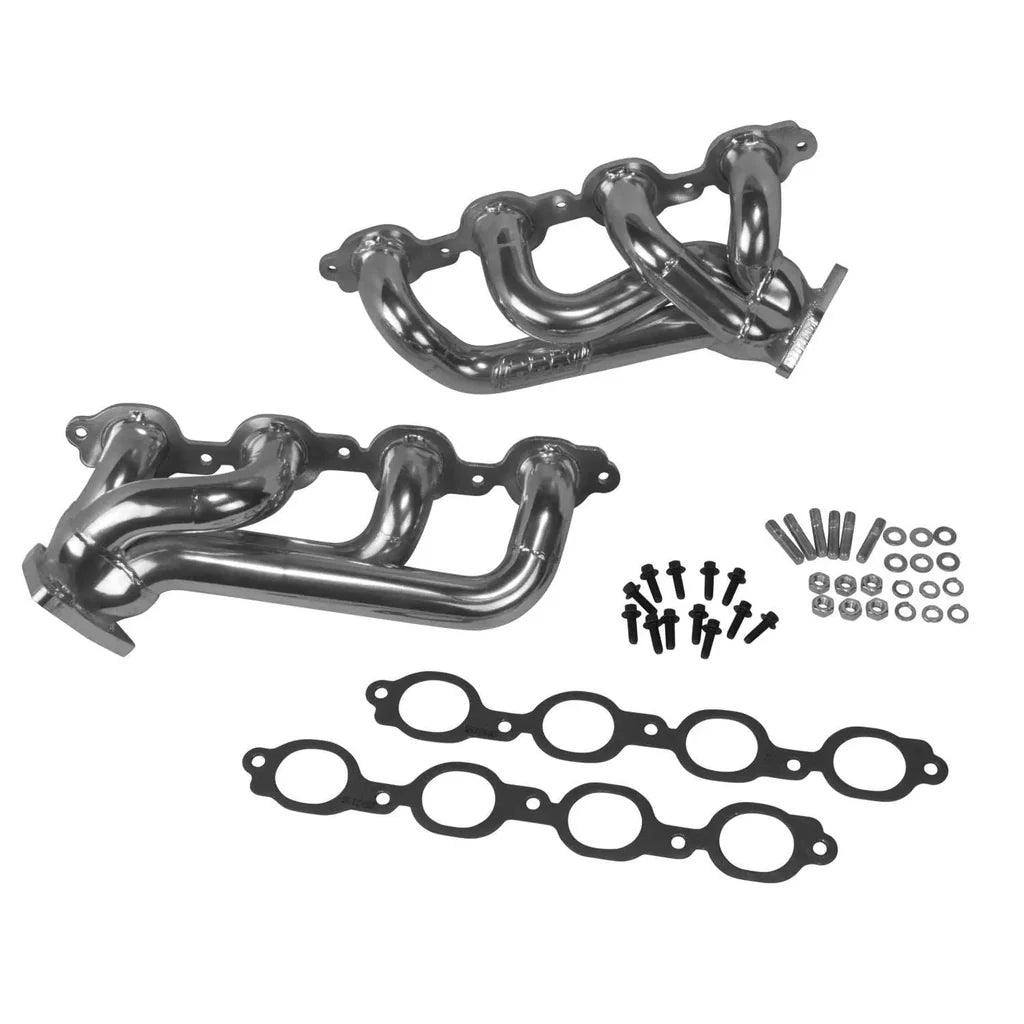 Metal exhaust manifold set with gaskets and bolts on a white background