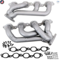 Metal exhaust manifold set with gaskets and bolts on a white background